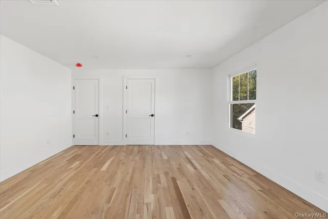 a view of room with window and hardwood floor