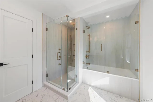 a bathroom with a shower and a bath tub
