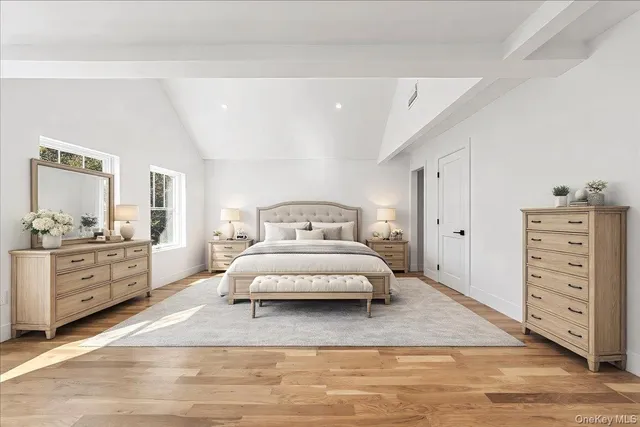 a spacious bedroom with a bed and cabinets