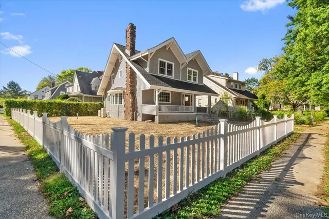 a front view of a house with wooden fence