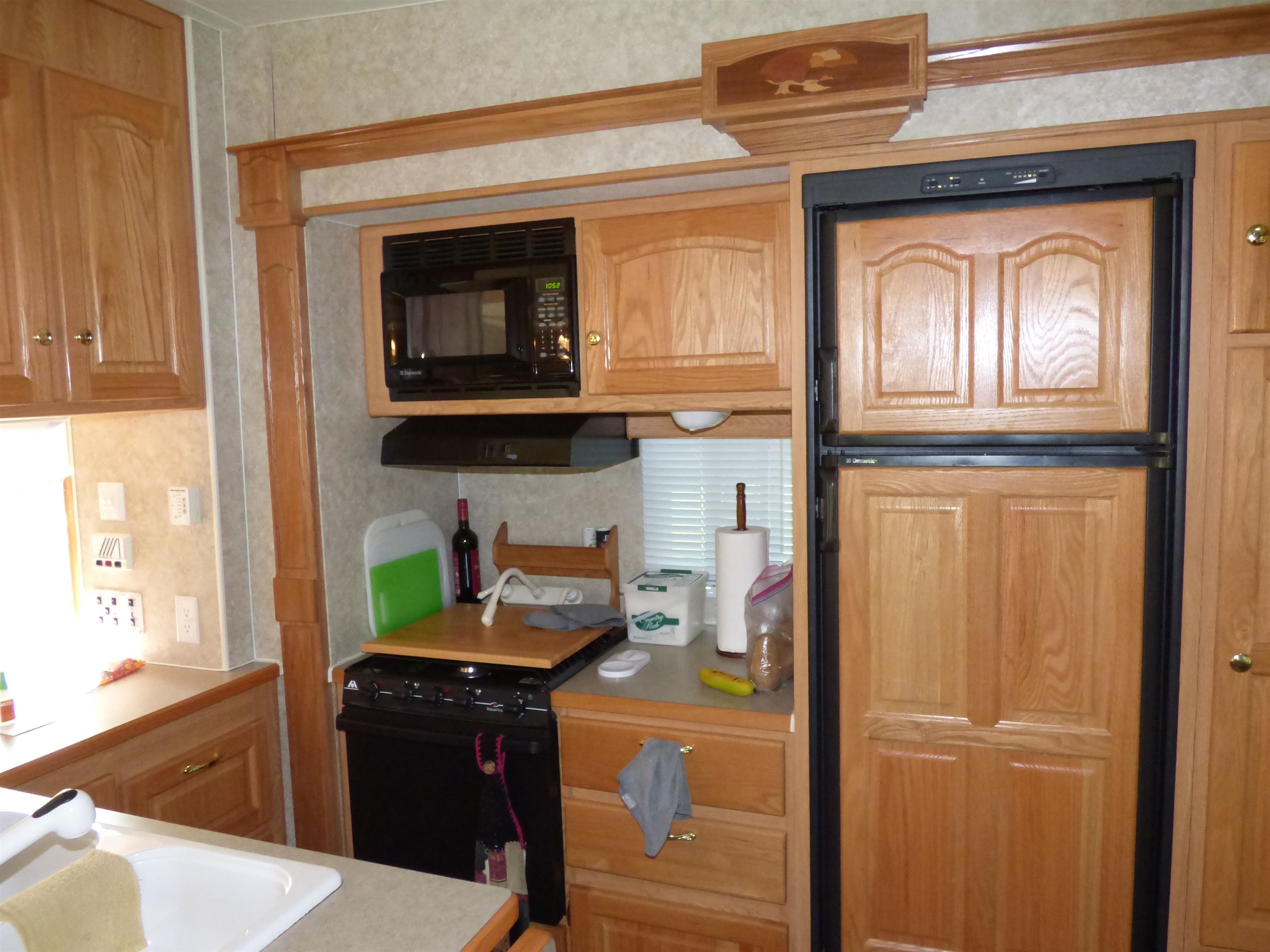 6384 A Diehl Road Savanna, IL 61074 - Photo 12 of 32 a kitchen with a refrigerator and a stove top oven