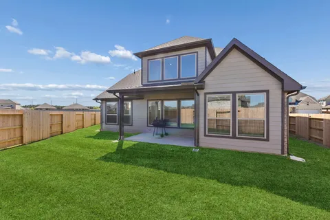 a view of a house with a yard and a garden