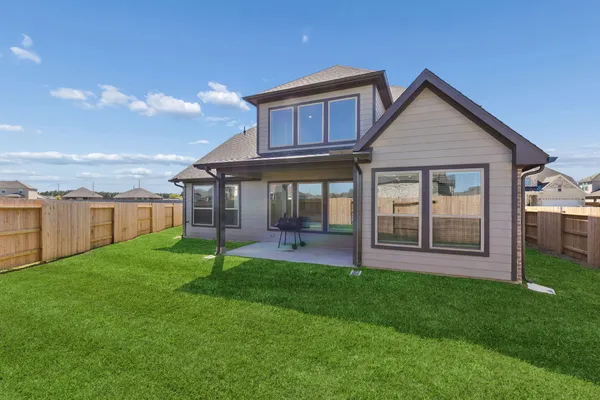a view of a house with a yard and a garden
