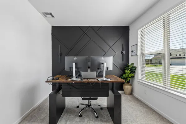 a view of a workspace with furniture