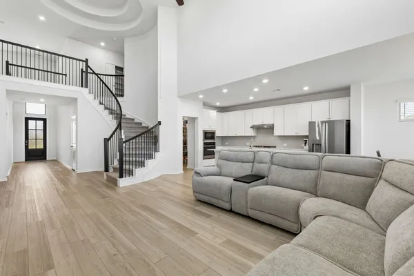 a living room with furniture and kitchen view