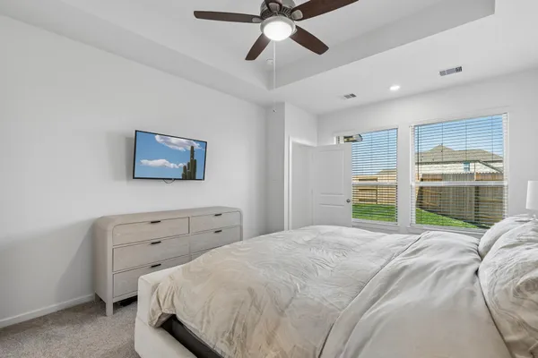 a bedroom with a bed and a flat screen tv