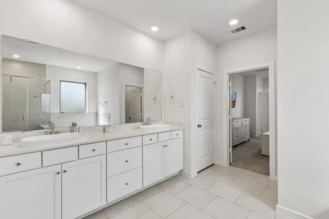 a spacious bathroom with a granite countertop sink mirror and toilet