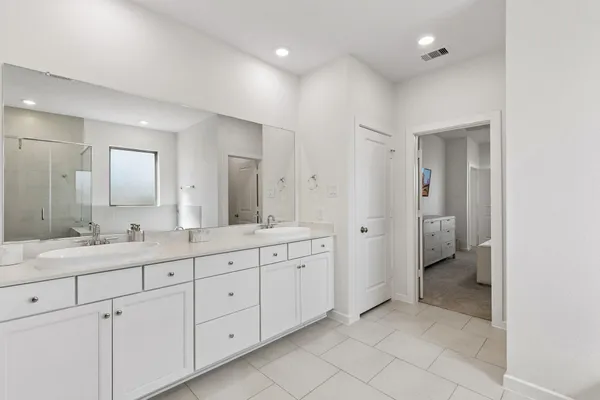 a spacious bathroom with a granite countertop sink mirror and toilet