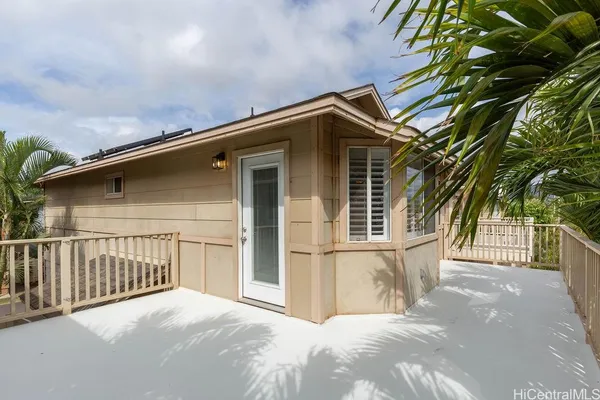a view of a house with a wooden fence