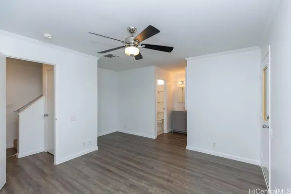 a view of an empty room and wooden floor