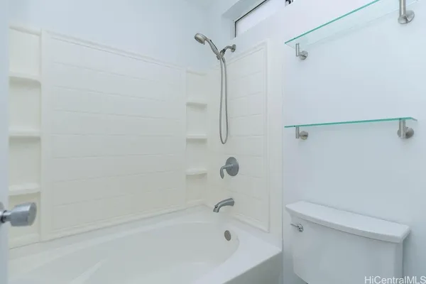 a bathroom with a bathtub and a toilet