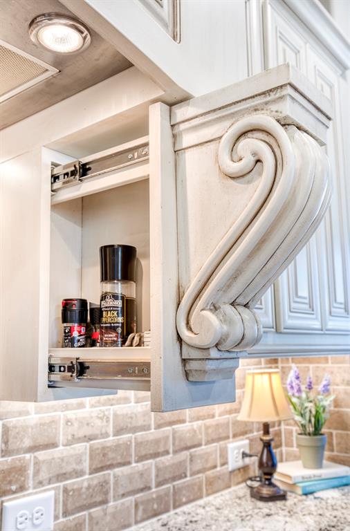 7760 Hackamore Street Frisco, TX 75036 - Photo 13 of 40 Don’t miss the hidden spice racks in the corbels and hidden trash drawer.