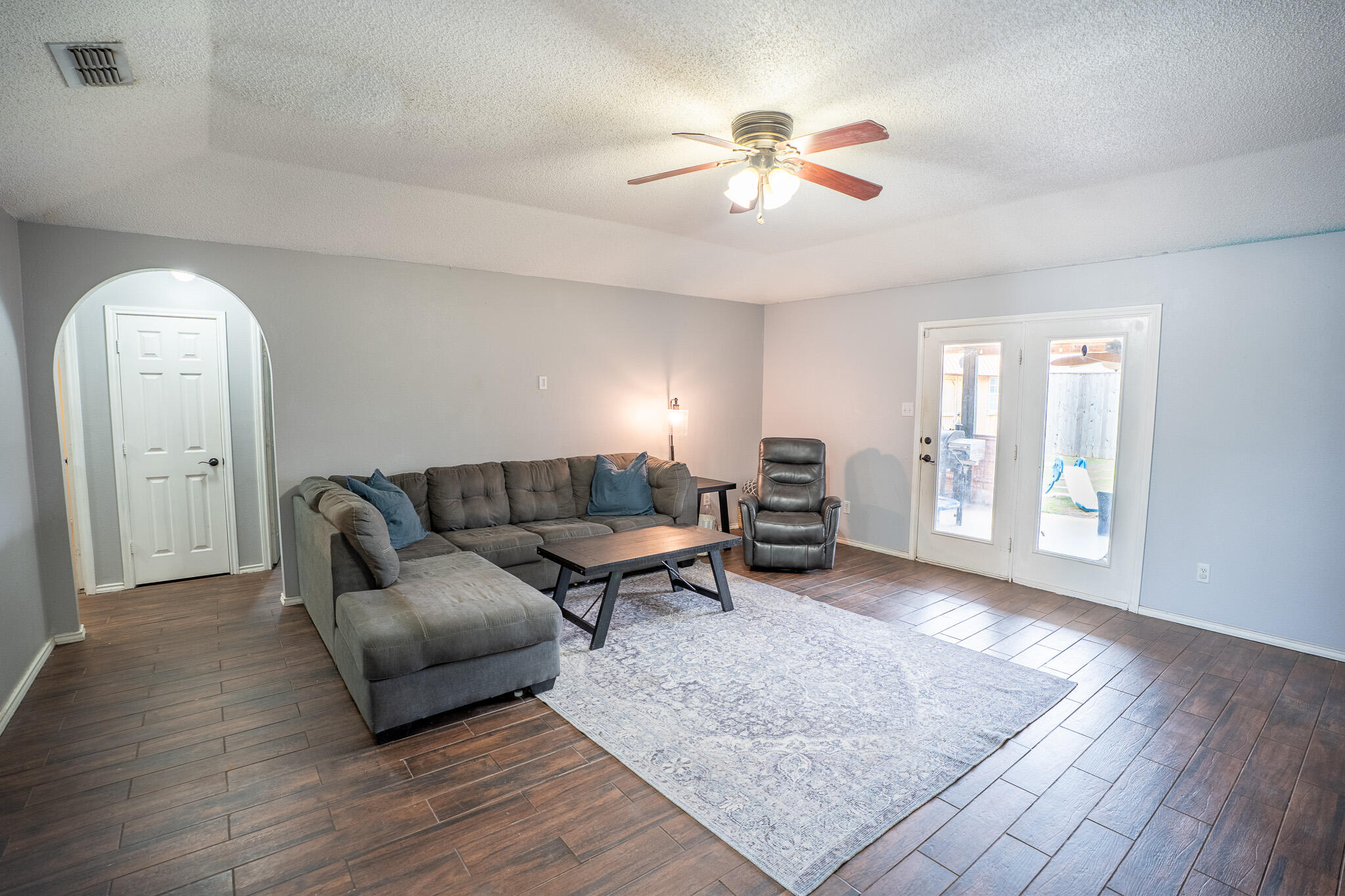 1609 78th Street Lubbock, TX 79423 - Photo 5 of 36 a living room with furniture and a chandelier