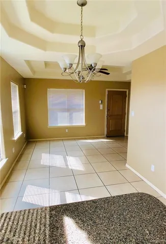 a view of a room with wooden floor and windows