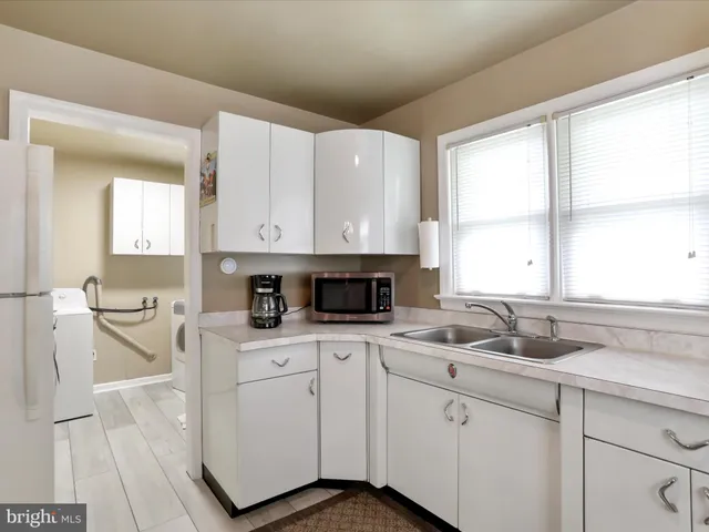 a kitchen with a sink cabinets and window