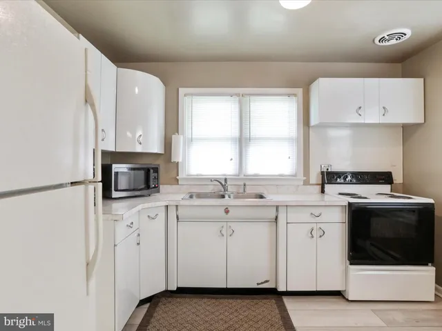 a kitchen with a sink stove and cabinets
