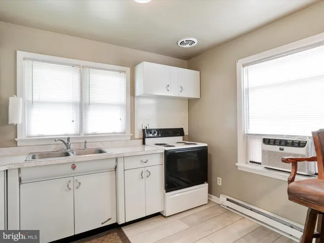 a kitchen with a sink stove and cabinets