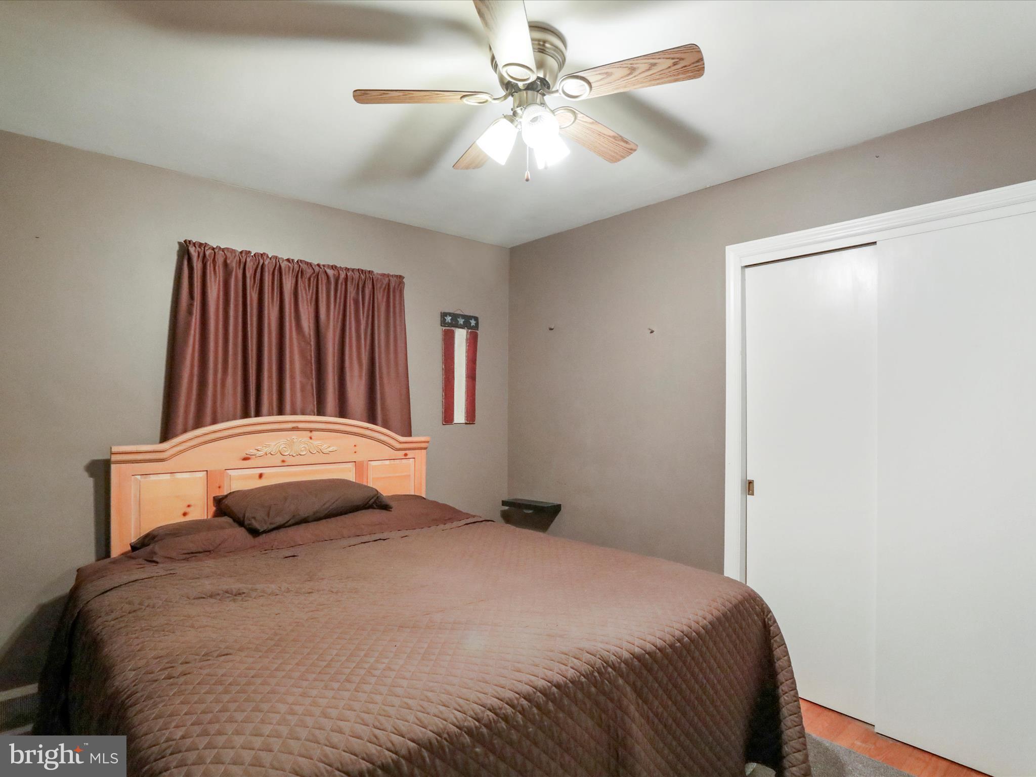 13517 Paradise Church Road Hagerstown, MD 21742 - Photo 9 of 38 a bedroom with a large bed and a chandelier