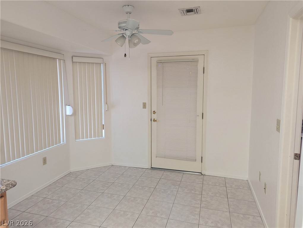 9433 Quail Ridge Drive Las Vegas, NV 89134 - Photo 7 of 23 A well-lit area featuring durable tiled flooring and a convenient outdoor access door.