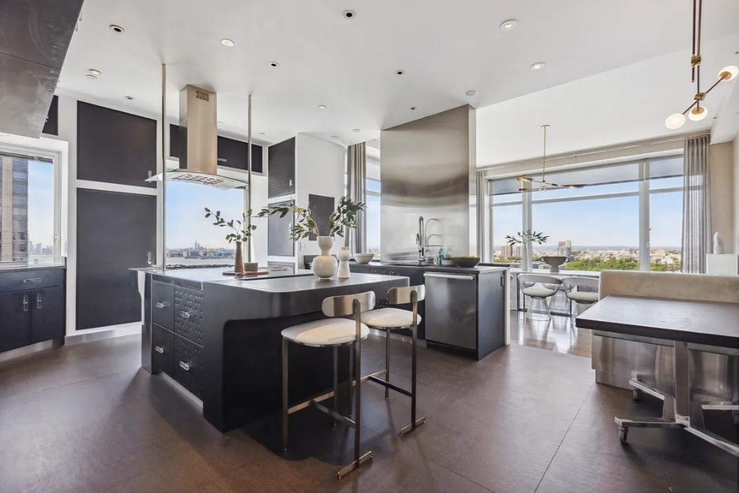 240 Riverside Boulevard, Unit SUITE1 Manhattan, NY 10069 - Photo 10 of 33 a kitchen with lots of counter top space and stainless steel appliances
