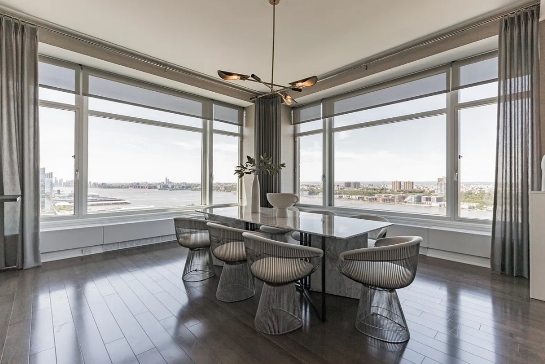 240 Riverside Boulevard, Unit SUITE1 Manhattan, NY 10069 - Photo 15 of 33 a dining room with furniture window and wooden floor