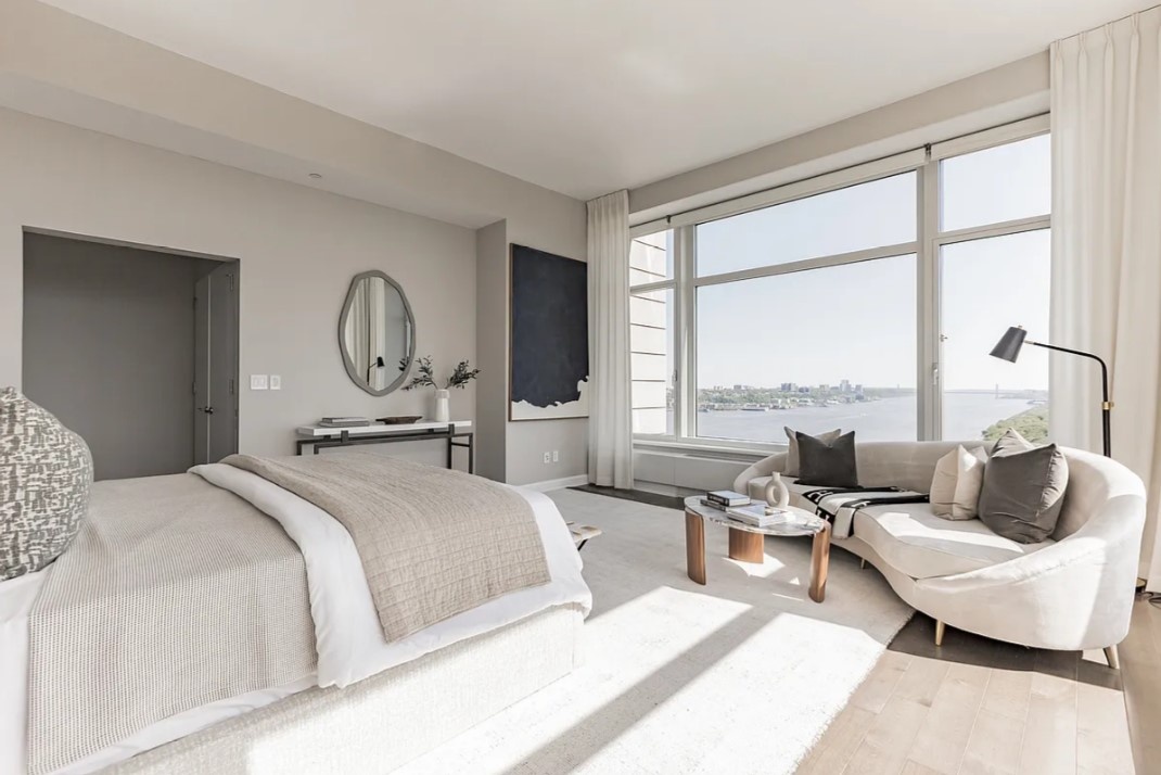 240 Riverside Boulevard, Unit SUITE1 Manhattan, NY 10069 - Photo 19 of 33 a bedroom with a bed couch and large window