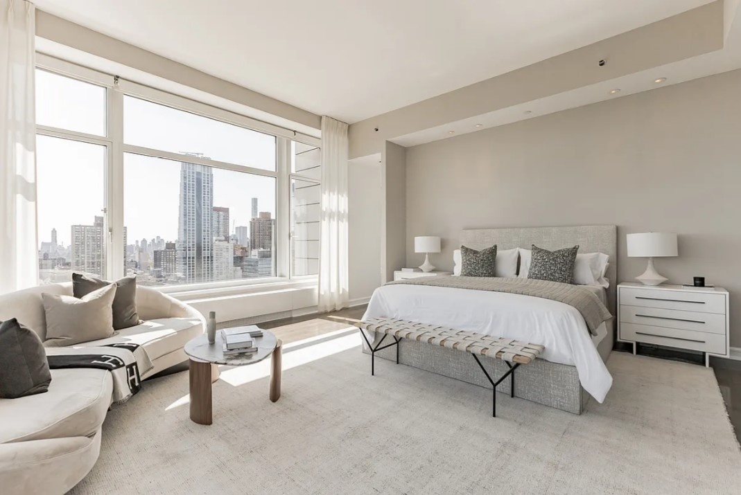 240 Riverside Boulevard, Unit SUITE1 Manhattan, NY 10069 - Photo 20 of 33 a spacious bedroom with a bed and large windows