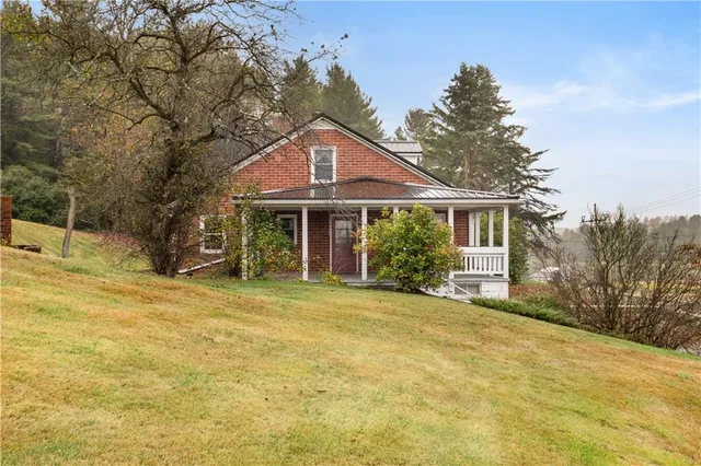 a front view of a house with a garden