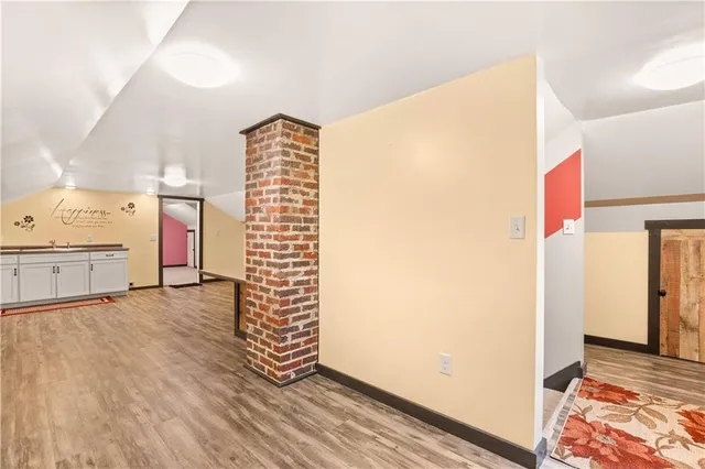 a living room with hard wood floors and a wooden floor