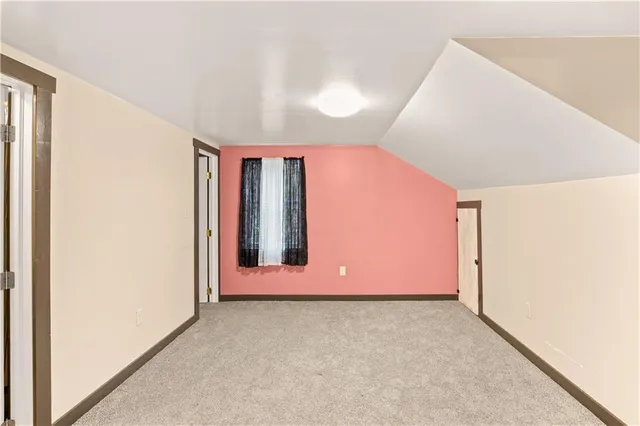 an empty room with a bathroom and a sink