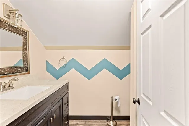 a bathroom with a bathtub a mirror and a sink