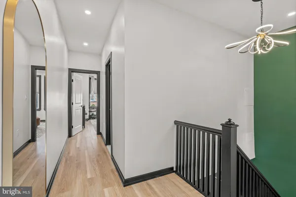 a view of a hallway with wooden floor
