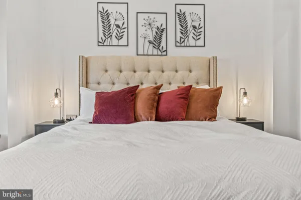 a bedroom with a bed and wall painting