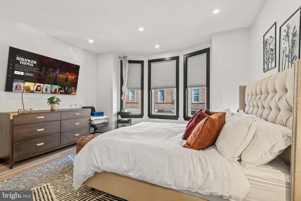 a bedroom with a bed and a flat screen tv