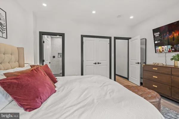 a bedroom with a bed and a dresser