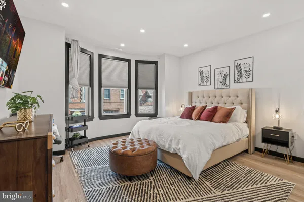 a spacious bedroom with a bed and a couch