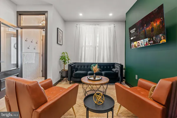 a living room with furniture and a chair