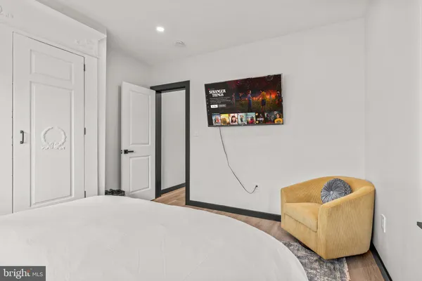 a bedroom with a bed and a couch