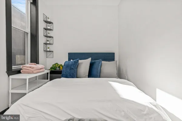 a large bed in a white room