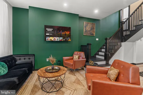 a living room with furniture and a flat screen tv