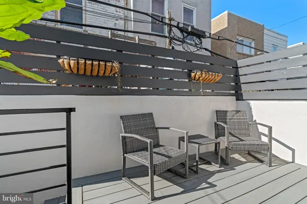 a terrace of a building with table and chairs
