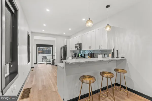 a large kitchen with lots of counter space and window