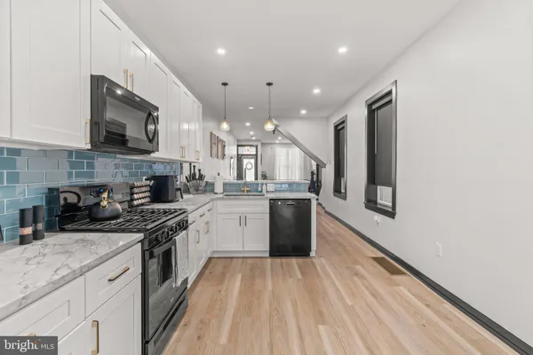 a kitchen with stainless steel appliances granite countertop lots of counter top space a sink and cabinets