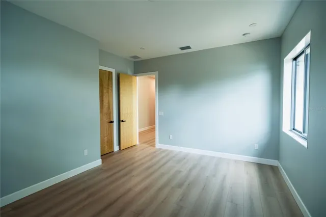 a bathroom with a sink mirror and a toilet