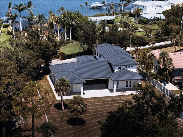an aerial view of a house with garden space and sitting area
