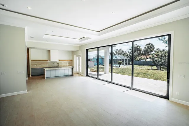 a view of an empty room with a fireplace and a large window