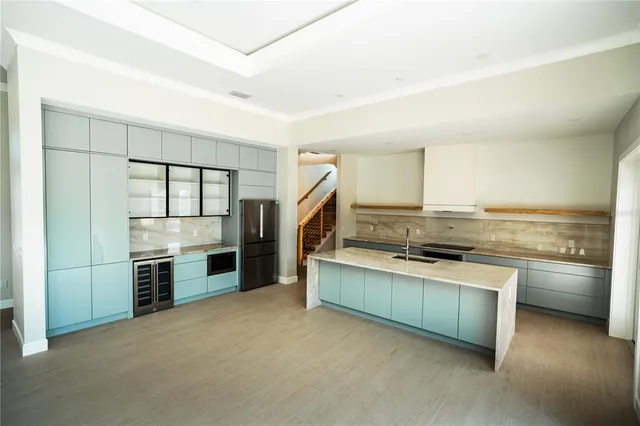 a kitchen with stainless steel appliances granite countertop a stove and a refrigerator