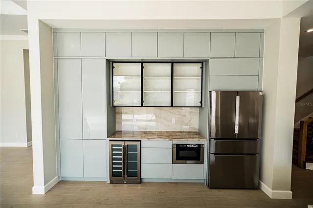 a kitchen with stainless steel appliances granite countertop a refrigerator and a sink
