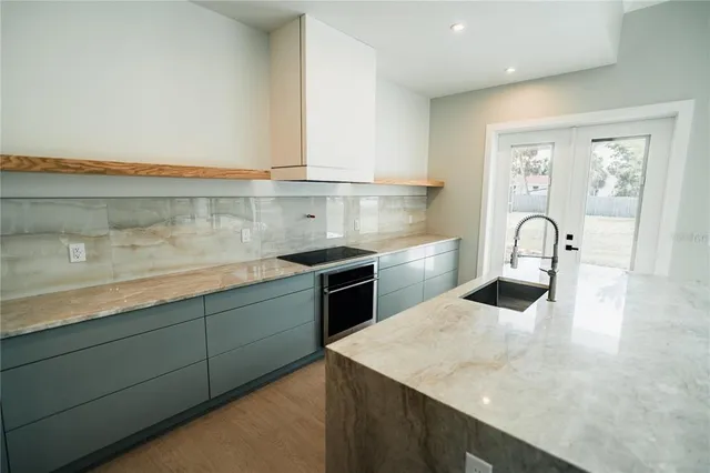 a kitchen with a sink and cabinets