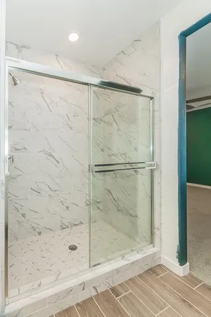 a bathroom with a double vanity sink toilet and shower
